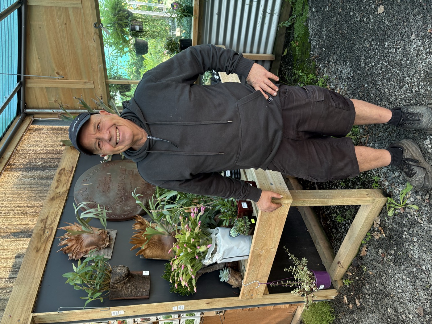 Domenic with the nursery's unique rustic display featuring staghorn ferns