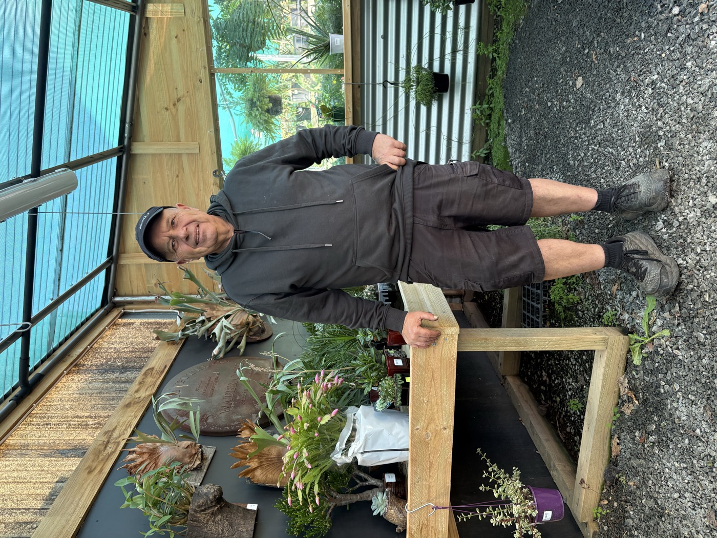 Domenic at the nursery surrounded by his unique collection of plants and rustic decor